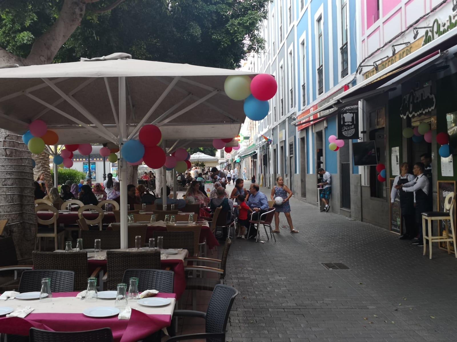 Terrace under white parasols, decorated with balloons